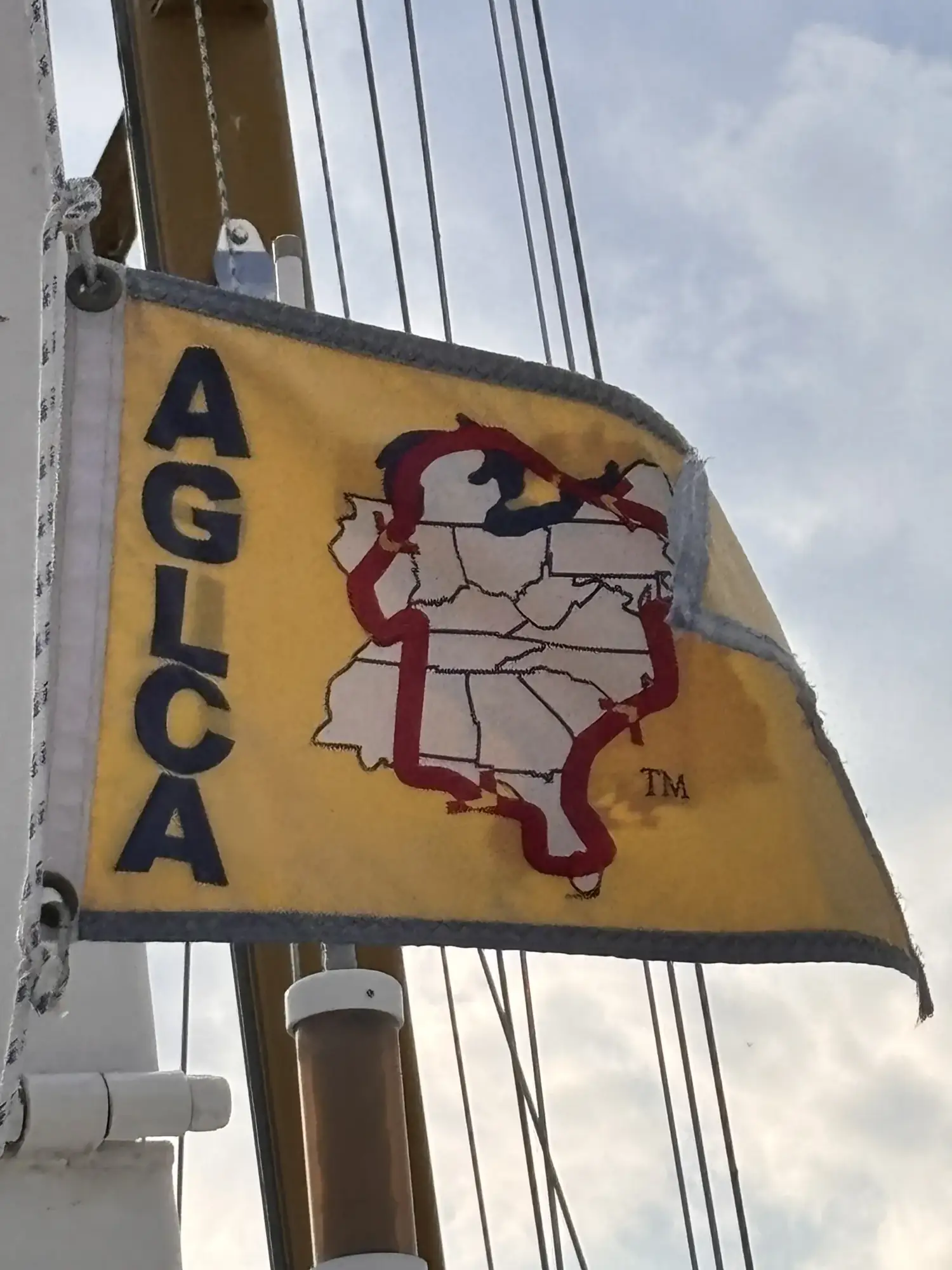 The gold AGLCA burgee flying aboard Sage