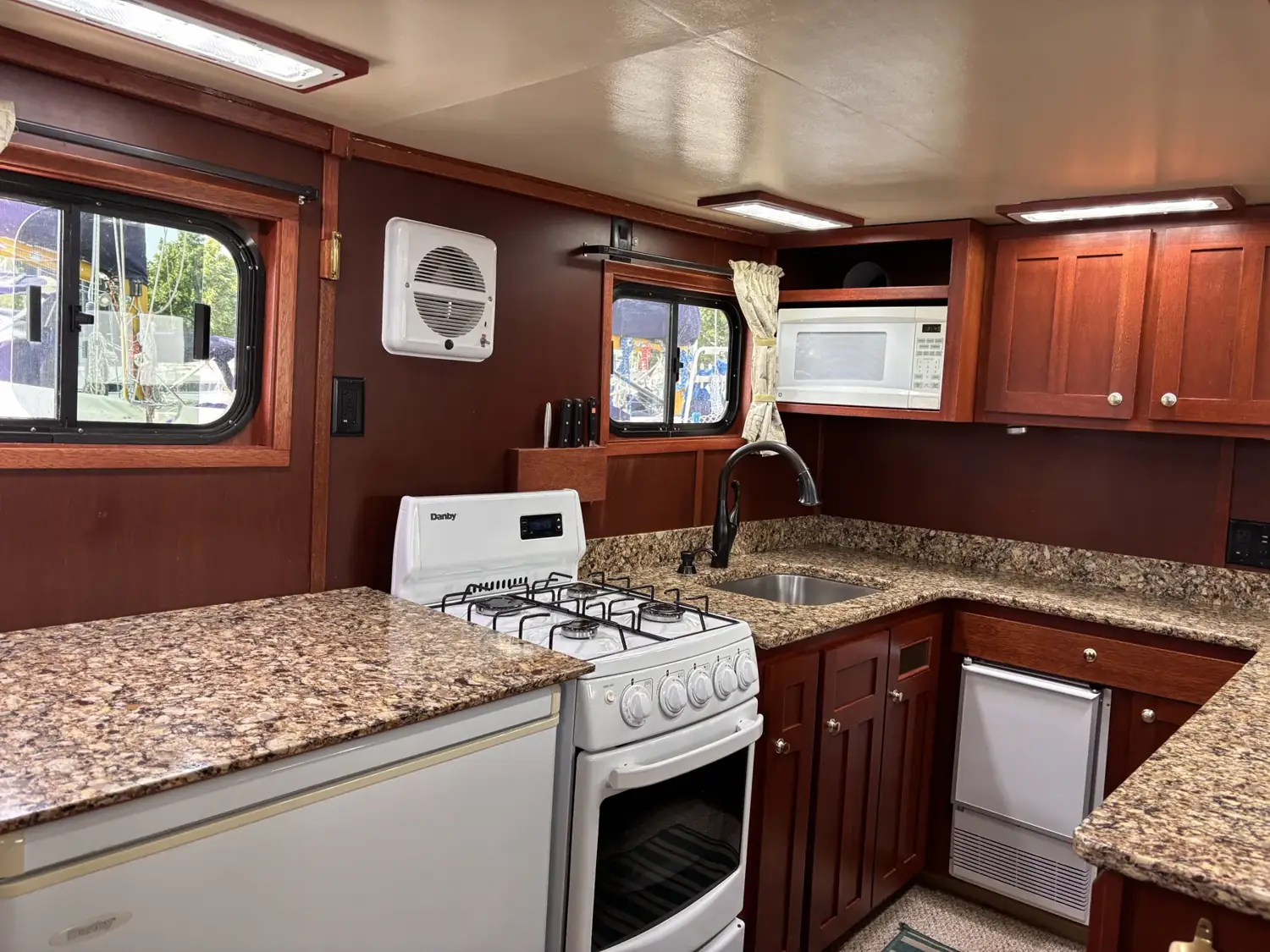 Chef's galley with quartz counters, propane range and custom cabinetry