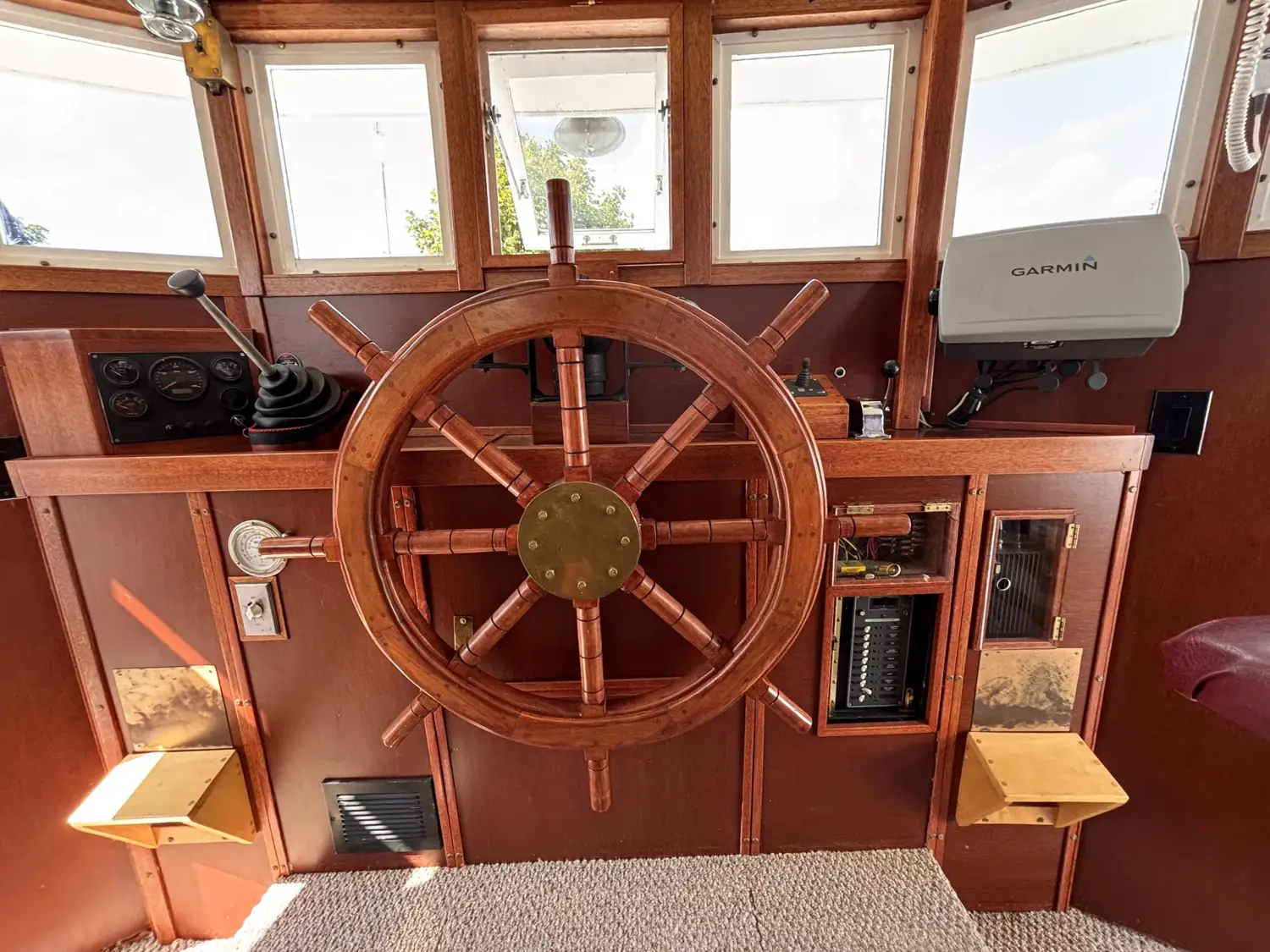 Sage's traditional ship's wheel, binnacle and Garmin electronics in daylight